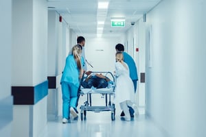 hospital-staff-pushing-patient-on-trolley